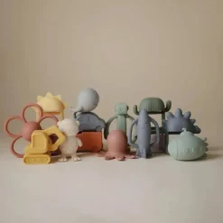 Mushie - Brinquedo mordedor de silicone para bebê com chocalho de foguete Discount